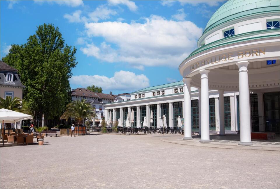 Historisches Kurhaus mit Säulen und Kuppel in Bad Pyrmont bei sonnigem Wetter.