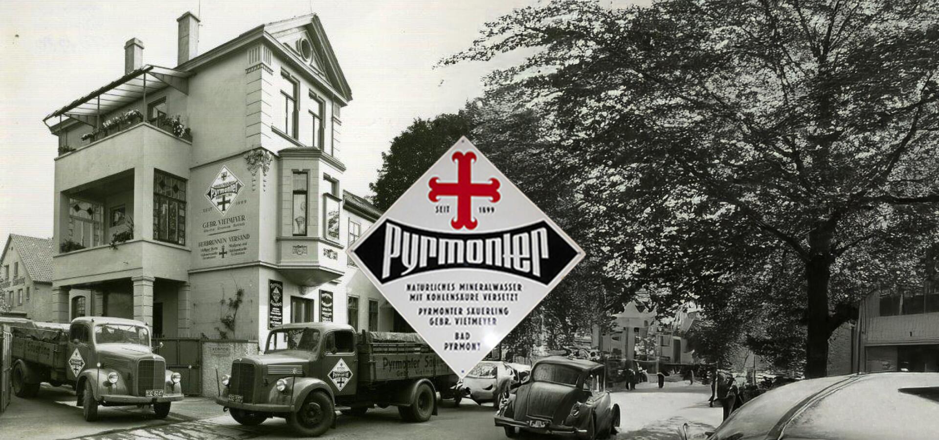 Altes Foto des Pyrmonter Mineralwasserwerks mit LKWs und historischem Firmenlogo.